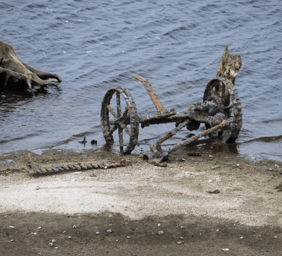 Ruins of homestead and farm machinery in lake uncovered