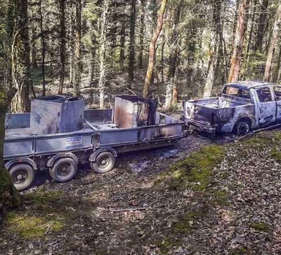Bank robbery getaway vehicle discovered burned out in wood