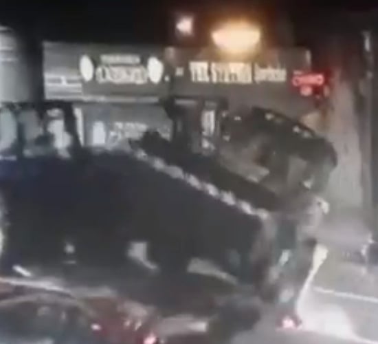 Video: Lorry carrying tractor and digger strikes bridge