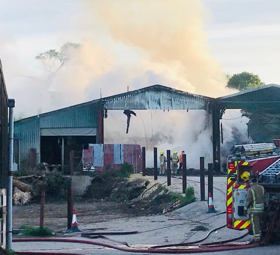 Firefighters tackle blaze affecting 6 barns on UK holding
