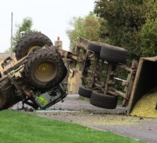 Lucky escape as tractor drawing maize flips onto roof