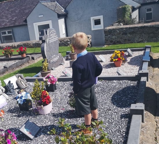 Telling daddy all about the first day at school – at his graveside