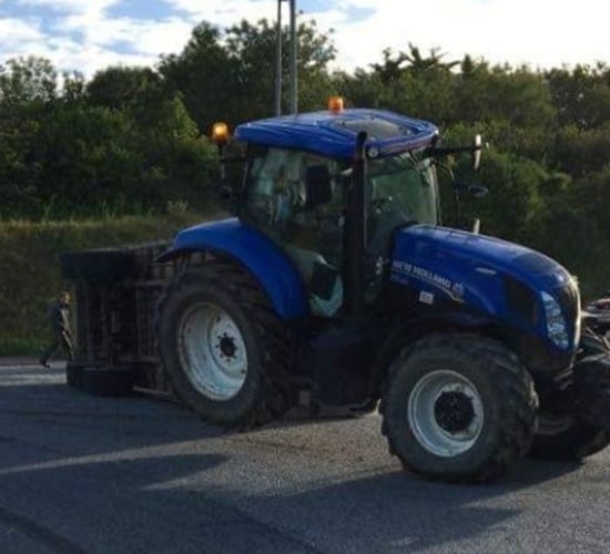 Livestock trailer carrying 12 cows overturns at roundabout