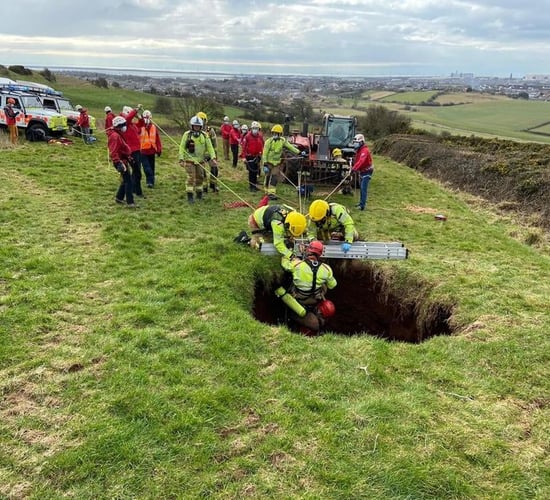 Farmer rescued after falling down 60ft sinkhole in field
