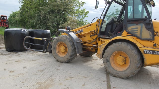 What is the correct way to stack round bales of silage?
