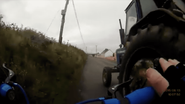 Dramatic footage of a tractor almost knocking a cyclist off their bike!