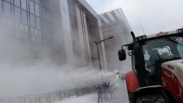 Pics: Farmers coat EU Council buildings with milk powder in protest
