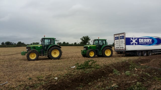 Pics: Tractors retrieve stranded articulated lorry from a field