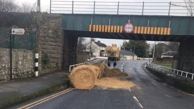The final 'straw': Tractor carrying bales strikes bridge