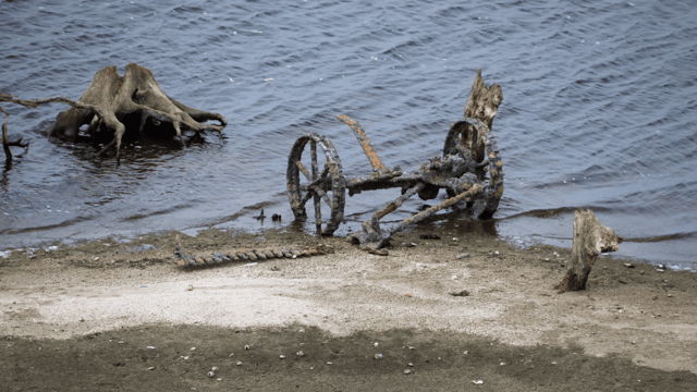 Ruins of homestead and farm machinery in lake uncovered