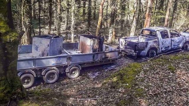 Bank robbery getaway vehicle discovered burned out in wood