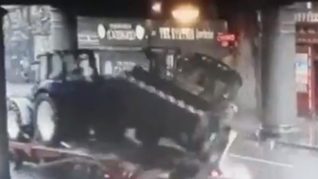 Video: Lorry carrying tractor and digger strikes bridge