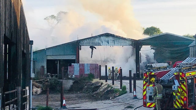 Firefighters tackle blaze affecting 6 barns on UK holding