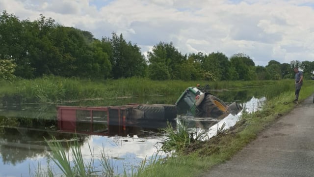 Tractor and silage trailer slides into Royal Canal