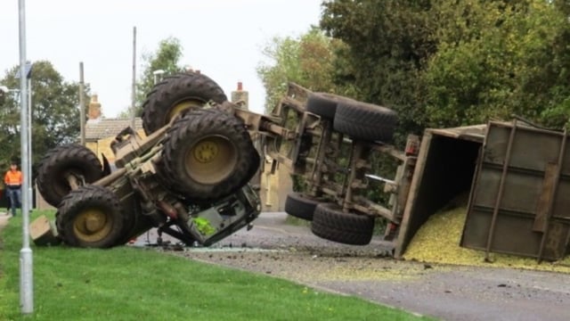 Lucky escape as tractor drawing maize flips onto roof