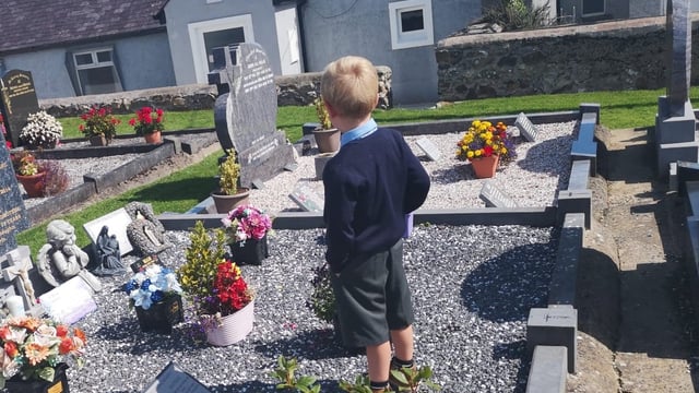 Telling daddy all about the first day at school – at his graveside
