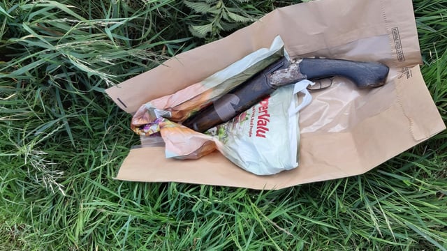 Sawn-off shotgun 'concealed behind water trough' in field