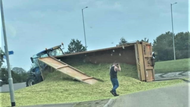 Overturned tractor trailer spills its contents all over the road