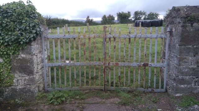 Farmyard wrought iron gates and stone piers preserved