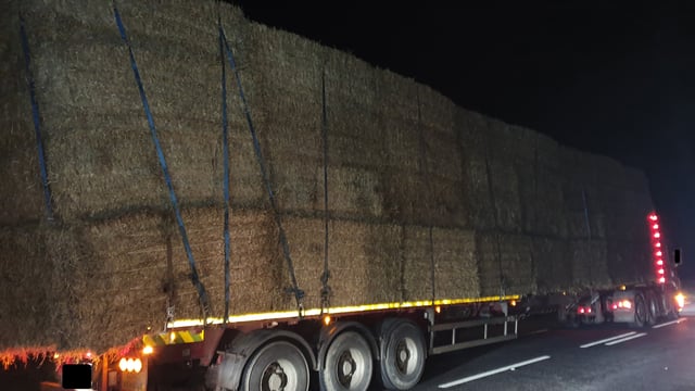 Court summons after extended flatbed lorry with straw stopped