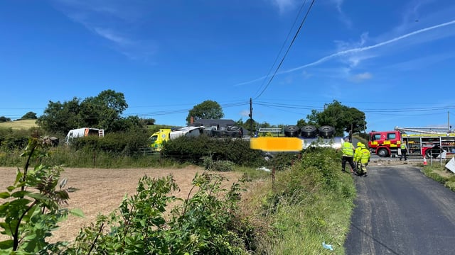 Gardaí and fire brigade attend scene of overturned milk lorry