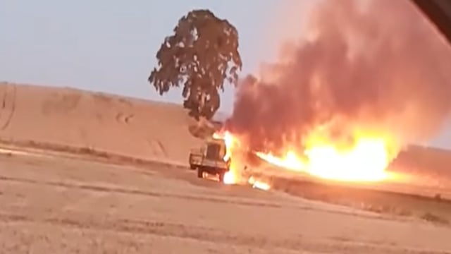 Video: Combine harvester catches fire as temperatures soar